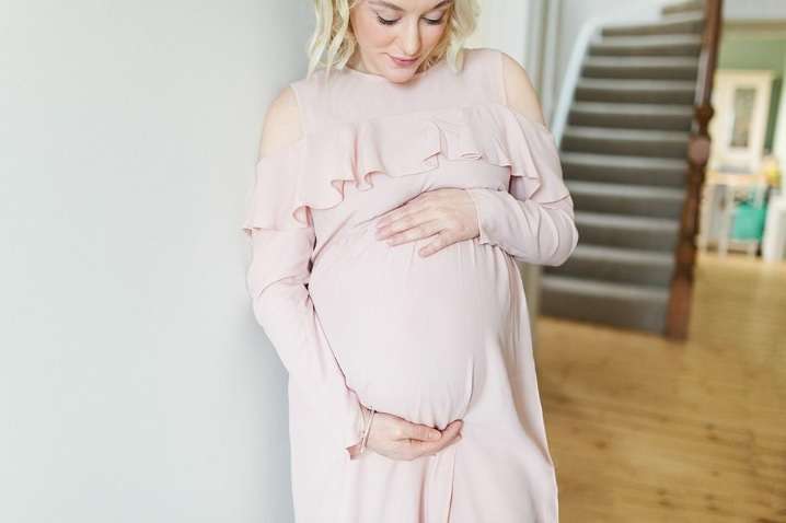 Mum to be holding her baby bump during a photoshoot in Glasgow with The Gibsons Photography
