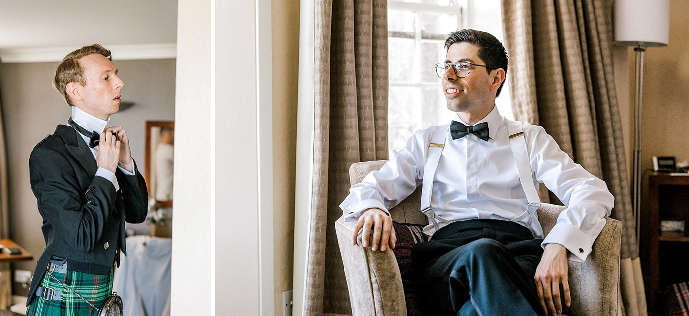Two men in formal attire are getting ready in a well-lit room. One, wearing a kilt, adjusts his collar while standing. The other, in braces and a bow tie, sits on a chair smiling. Curtains and a window are in the background.