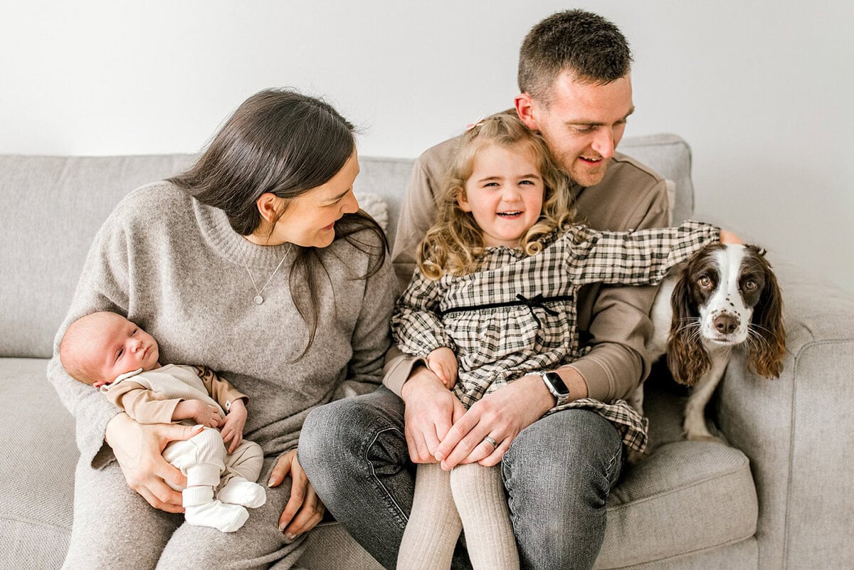 Happy family with two children and dog during in-home photoshoot in Glasgow.